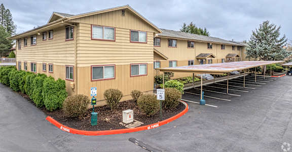 A large building with a parking lot in front of it.