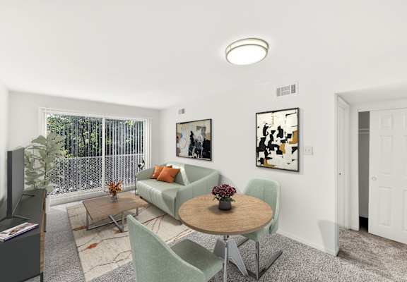 a living room with a couch and a table and chairs