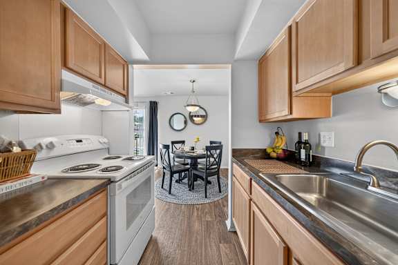 A kitchen with wooden cabinets and a stove top oven.