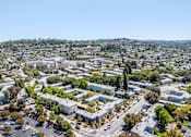 Thumbnail 11 of 11 - A bird's eye view of a residential area with houses, trees, and roads.