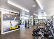 Thumbnail 4 of 11 - A gym with a poster that says "CONQUER" on it.