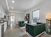 Thumbnail 14 of 28 - A modern kitchen with white cabinets and a green island.