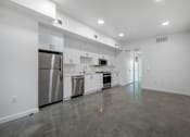Thumbnail 7 of 28 - A spacious kitchen with stainless steel appliances and white cabinets.