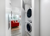 Thumbnail 6 of 6 - A red couch is in the background of a laundry room.
