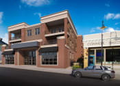 Thumbnail 9 of 10 - a building with a car parked in front of it