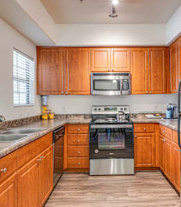 A kitchen with wooden cabinets and stainless steel appliances.