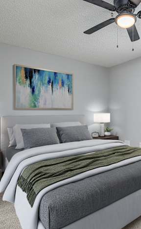 A bedroom with two beds, a ceiling fan, and a painting on the wall.