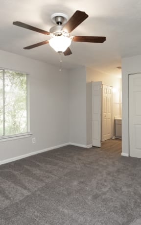an empty living room with a ceiling fan and a window at Hidden Woods, Georgia