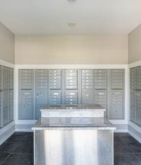 A room with a long table and a wall of mailboxes.
