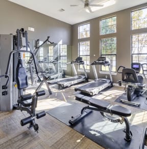 a gym with exercise equipment and windows