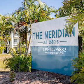 A sign for The Meridian at 2825 with a phone number and website.