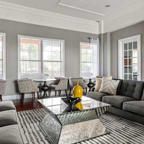A living room with a couch, chairs, and a coffee table.