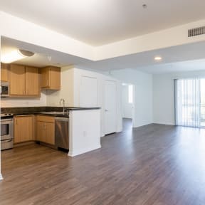 a kitchen and living room in an apartment  at Legacy Apartments, CA, 91325
