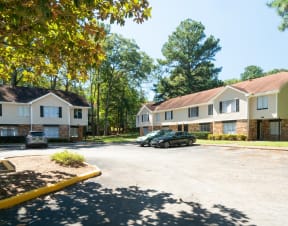 a parking lot in front of a row of houses at Hidden Woods, Georgia