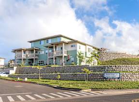 A building with a sign that says "Waterfall Ridge" in front of it.