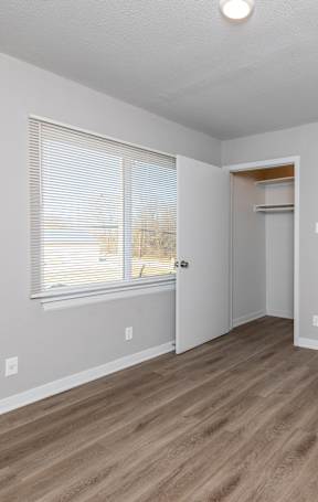 A room with a wooden floor and white walls. at Blacklark Apartments, Apartments, Kansas City, KS