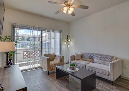 A living room with a couch, chair, and table.