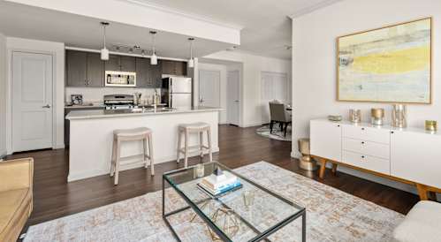 Spacious living room and kitchen with ceiling fan. 
