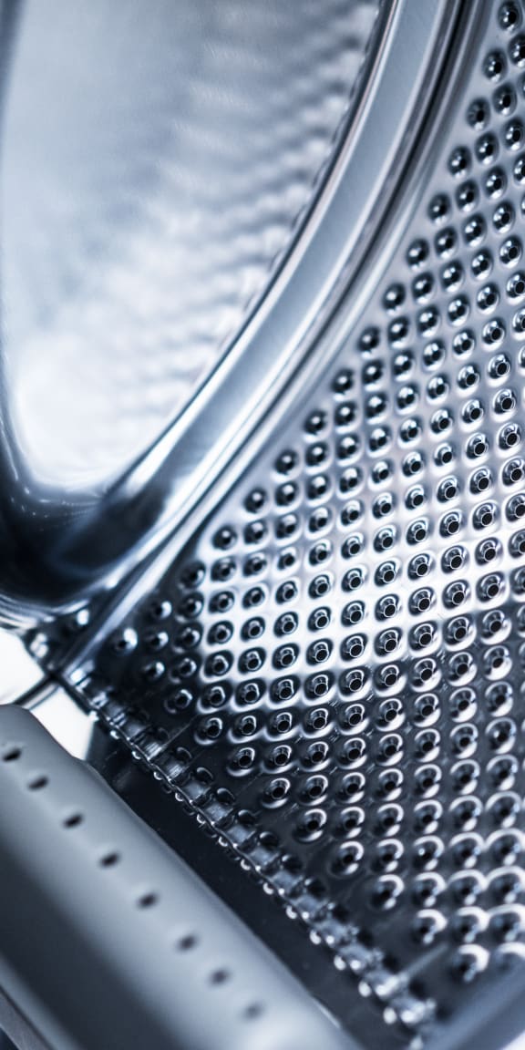a close up of a microwave oven with a cheese grater in front of it
