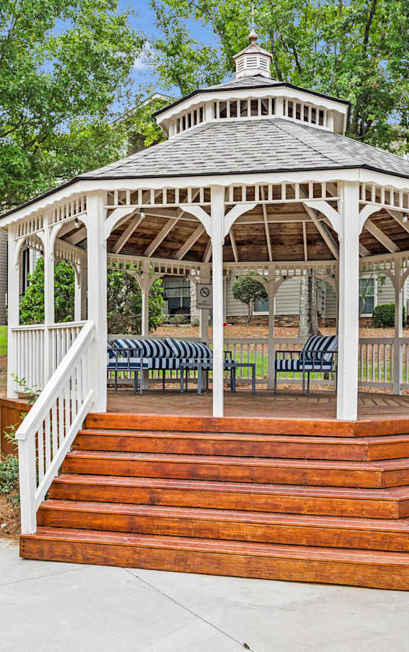 A wooden playground structure with a green slide.