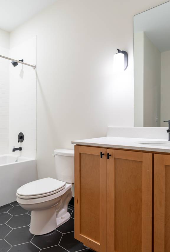 Bathroom with tub, toilet and sink at The Yard Apartments, Louisville