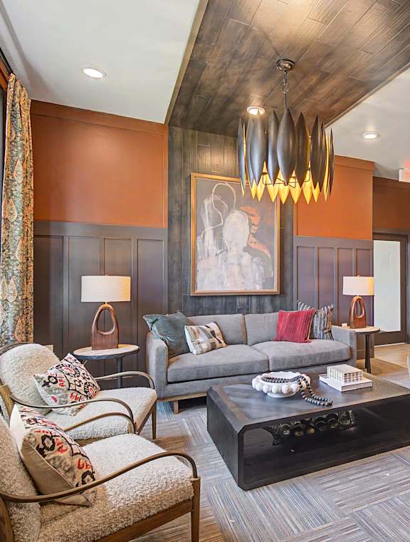 A living room with a grey couch and a brown chair.