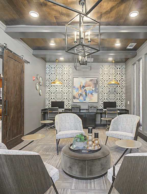 A living room with a large window and a dining area in the background.