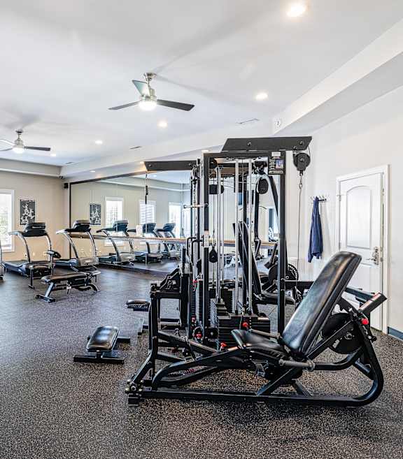 A spacious home gym with a variety of exercise equipment.