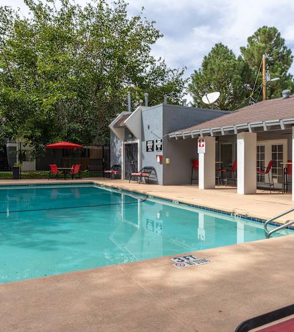 A swimming pool with a building in the background.