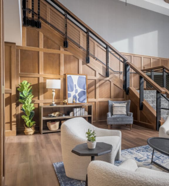 a living room with a staircase and a rug