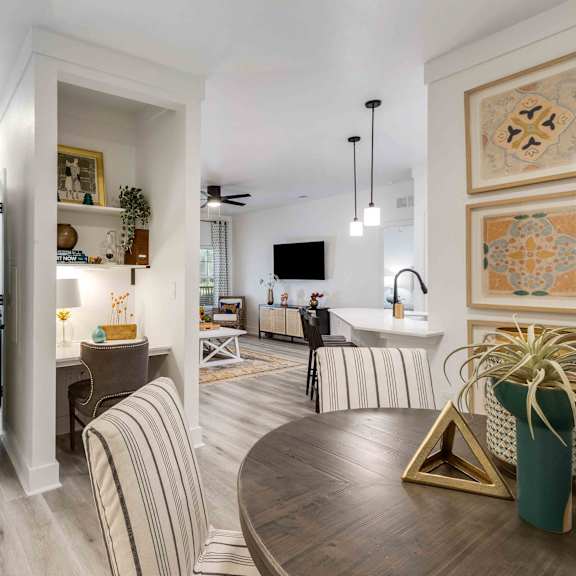 A modern living room with a wooden floor and a striped sofa.