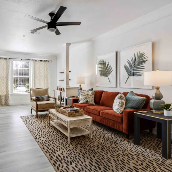 a living room with a couch and a ceiling fan