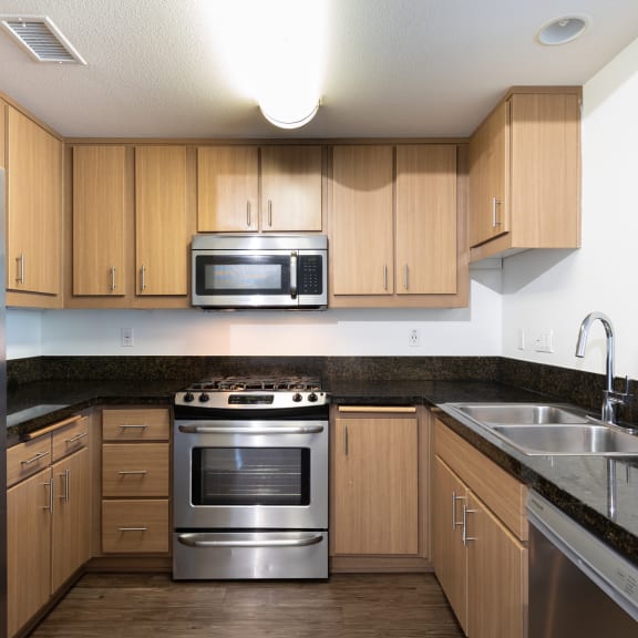 a kitchen and living room in an apartment  at Legacy Apartments, Northridge, 91325
