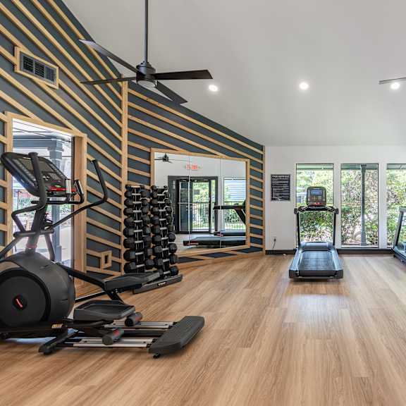 A room with a fireplace and wood flooring.
