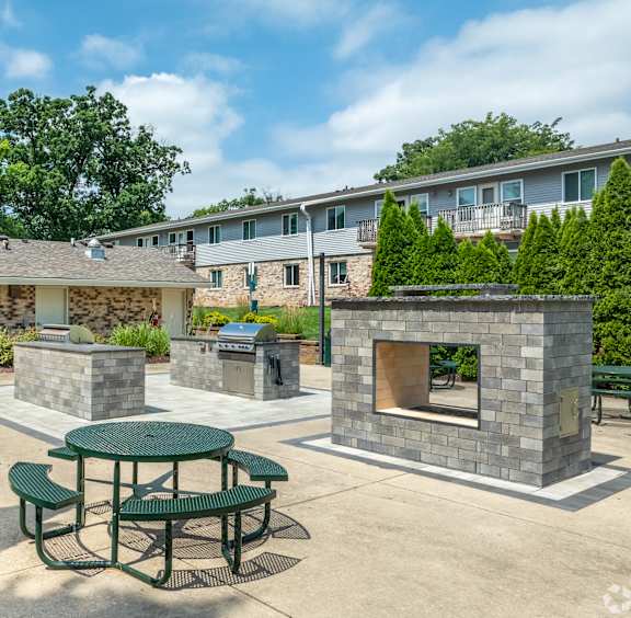 a tennis court with a house in the background