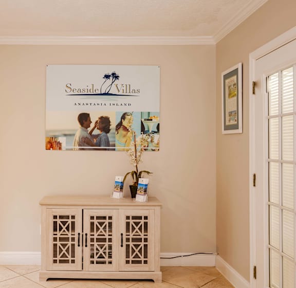 A room with a Seaside Villas sign on the wall.