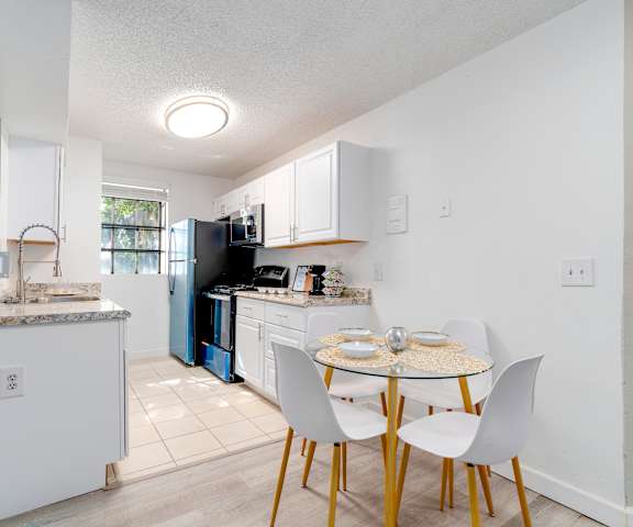 a kitchen and dining area with a small table and chairs