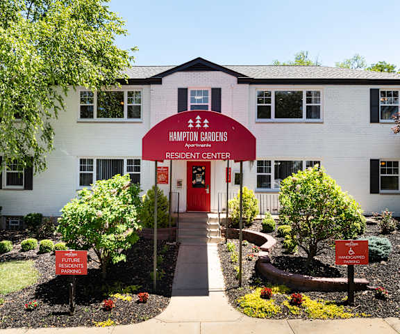 a white building with a red sign in front of it
