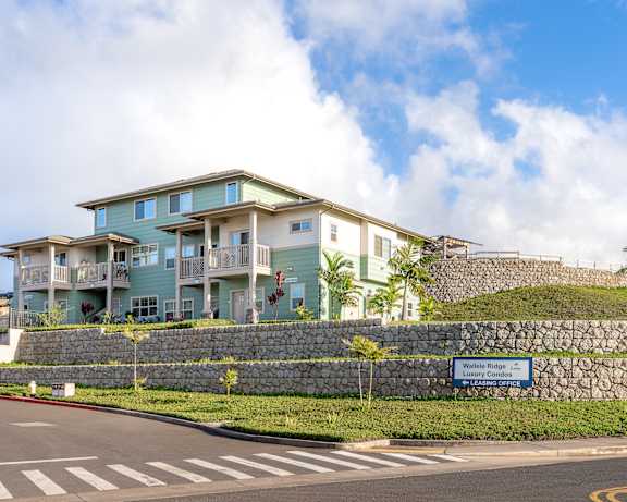 A building with a sign that says "Waterfall Ridge" in front of it.