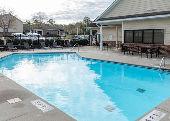 A swimming pool with a building in the background.