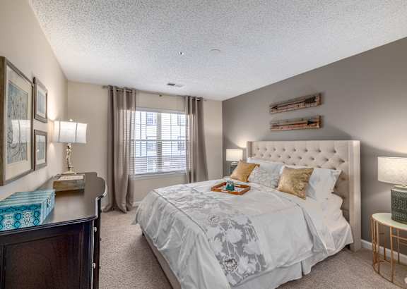 Bedroom with a large comfortable bed and window at Radbourne Lake Apartments, North Carolina, 28269