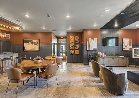 A modern dining room with a wooden table and chairs.