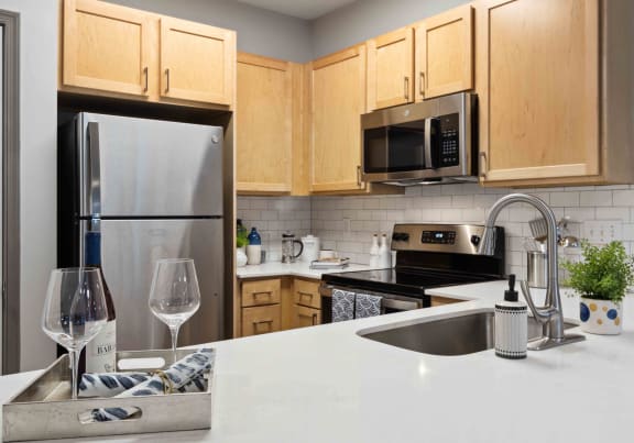 Sage at 1240 apartments in Mount Pleasant South Carolina photo of kitchen with stainless steel appliances and quartz countertops.
