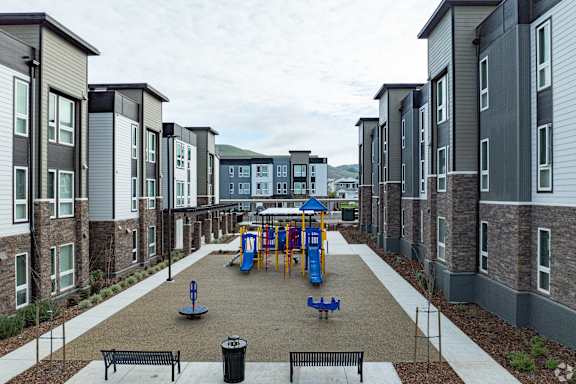 a rendering of a three story apartment building with a woman pushing a stroller in front of