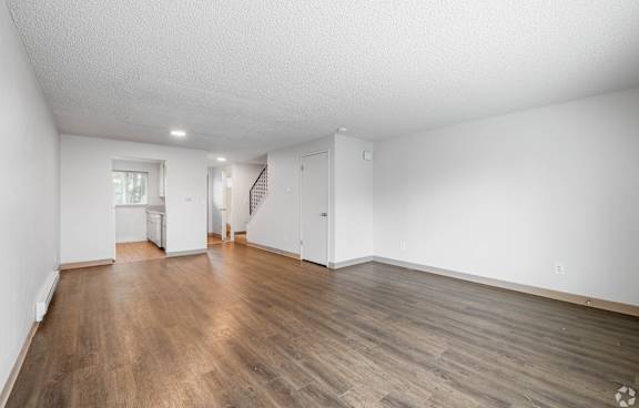 A room with wooden floors and white walls.