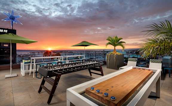 A patio with a fire pit and seating area.