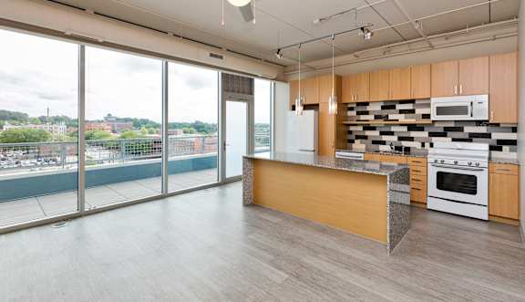 A kitchen with a view of the city.