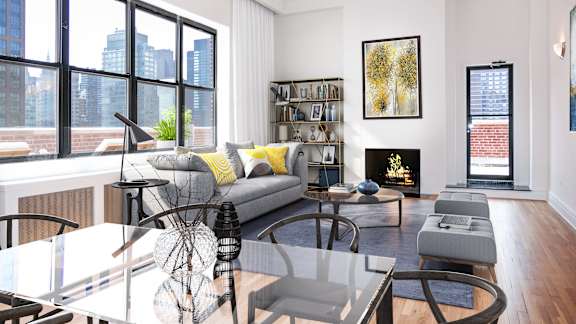 A modern living room with a glass table and a grey couch.at Sutton Collection, New York New York