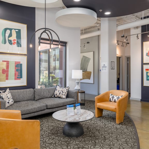 a living room with a couch and chairs and a table