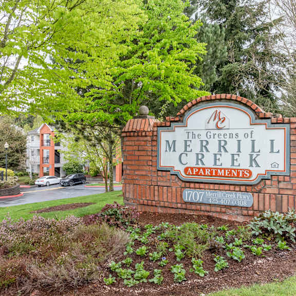 entrance sign to the greens apartments